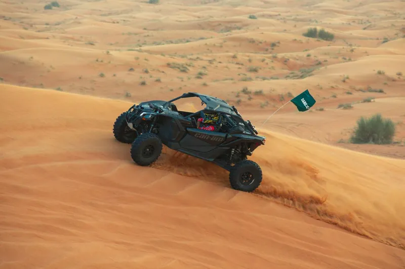 Can-Am Maverick X3 driving across a dune slope