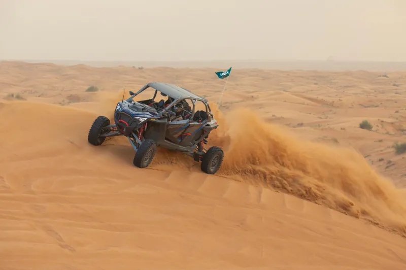 Polaris RZR Pro R four-seat buggy coming down a dune