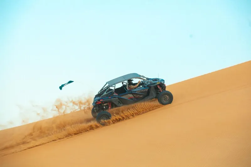 Polaris RZR Pro R four-seat buggy climbing a steep dune