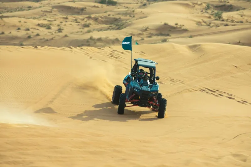 Polaris RZR RS1 heading down a golden dune