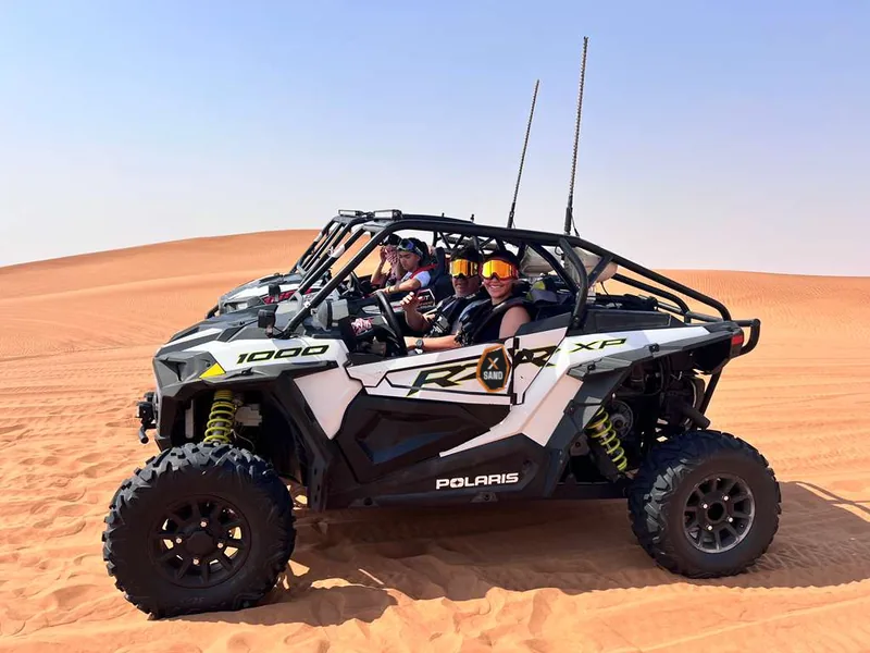 Side view of a Polaris RZR XP 1000 on desert sand