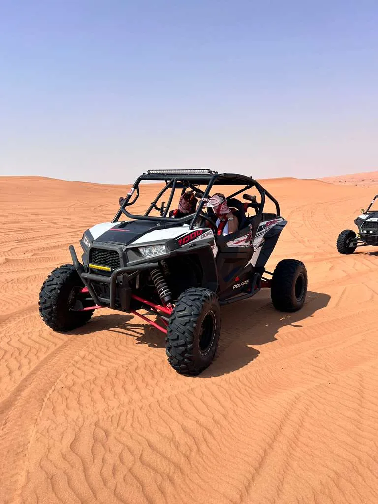 White and red Polaris RZR XP 1000 on a dune